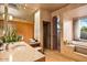 Luxurious bathroom with granite counters, dual sinks, and a soaking tub at 9962 E Groundcherry Ln, Scottsdale, AZ 85262