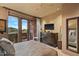 Serene bedroom featuring a private balcony, comfortable furnishings, and ample natural light at 9962 E Groundcherry Ln, Scottsdale, AZ 85262