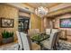 Bright dining room featuring a chandelier, and view of the home's entrance at 9962 E Groundcherry Ln, Scottsdale, AZ 85262