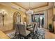 Elegant dining room featuring a chandelier, large mirror, and view of the desert landscape at 9962 E Groundcherry Ln, Scottsdale, AZ 85262