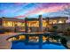 Beautiful home with a pool, desert landscaping, and scenic mountain views, creating a tranquil oasis at 9962 E Groundcherry Ln, Scottsdale, AZ 85262