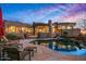 Luxury home with a stunning pool, patio area, desert landscaping, and expansive mountain views at sunset at 9962 E Groundcherry Ln, Scottsdale, AZ 85262