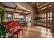 Grand foyer with soaring ceilings, stone columns, tile floors, and a red grand piano at 9962 E Groundcherry Ln, Scottsdale, AZ 85262