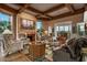 Comfortable living room with desert views, wood beam ceilings and fireplace at 9962 E Groundcherry Ln, Scottsdale, AZ 85262