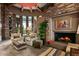 Inviting living room with a fireplace, beamed ceiling, and view of the staircase at 9962 E Groundcherry Ln, Scottsdale, AZ 85262