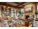 Inviting living room with a fireplace, wet bar, and comfortable seating at 9962 E Groundcherry Ln, Scottsdale, AZ 85262