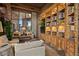 Cozy living room featuring a window view, built-in shelves, and comfortable seating at 9962 E Groundcherry Ln, Scottsdale, AZ 85262