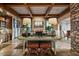 Spacious living room featuring wood beam ceilings, fireplace, and stylish seating at 9962 E Groundcherry Ln, Scottsdale, AZ 85262