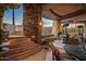 Cozy outdoor living space with a brick pillar, a covered dining area, and mountain views at 9962 E Groundcherry Ln, Scottsdale, AZ 85262