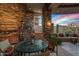 Inviting outdoor living area with brick accents, a dining table, and an open view of mountains at 9962 E Groundcherry Ln, Scottsdale, AZ 85262