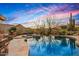 Beautiful pool with desert landscape, mountain views, and natural stone accents, perfect for relaxation at 9962 E Groundcherry Ln, Scottsdale, AZ 85262