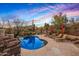 Desert backyard with a free form pool, lounge chairs, desert landscaping, and mountain views at 9962 E Groundcherry Ln, Scottsdale, AZ 85262