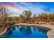 Relaxing pool and patio area featuring comfortable lounge chairs, desert views, and lush landscaping at 9962 E Groundcherry Ln, Scottsdale, AZ 85262