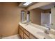 Bathroom featuring dual sinks, a large vanity, and well-lit mirrors at 10236 E Minnesota Ave, Sun Lakes, AZ 85248
