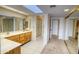 Spacious bathroom featuring dual sinks, vanity, and well-lit mirrors at 10236 E Minnesota Ave, Sun Lakes, AZ 85248