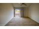 Bedroom features a ceiling fan and a sliding glass door leading to outdoor space at 10236 E Minnesota Ave, Sun Lakes, AZ 85248