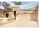 Charming home featuring a two-car garage and a distinctive red tile roof detail over the entryway at 10236 E Minnesota Ave, Sun Lakes, AZ 85248