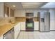 Bright kitchen featuring white cabinetry, stainless steel appliances, and tiled flooring at 10236 E Minnesota Ave, Sun Lakes, AZ 85248