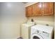 Utility room featuring a washer and dryer with upper cabinet storage at 10236 E Minnesota Ave, Sun Lakes, AZ 85248