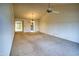 Bright living room with carpet, ceiling fan, and open access to the dining area and other rooms at 10236 E Minnesota Ave, Sun Lakes, AZ 85248