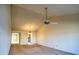 Bright living room with carpet, ceiling fan, and open access to the dining area and other rooms at 10236 E Minnesota Ave, Sun Lakes, AZ 85248
