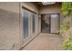 Private brick patio enclosed with a sliding door, french doors and a textured wall at 10236 E Minnesota Ave, Sun Lakes, AZ 85248