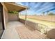 Outdoor patio area with a covered area, and a brick paver extension protected by a stylish wrought iron fence at 10236 E Minnesota Ave, Sun Lakes, AZ 85248