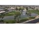 Aerial shot of a community with a well maintained pond, water feature, and nearby golf course at 10236 E Minnesota Ave, Sun Lakes, AZ 85248