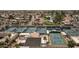 Aerial view of well-maintained community tennis courts surrounded by residential homes and a pond at 10236 E Minnesota Ave, Sun Lakes, AZ 85248