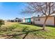 Large backyard with lush green grass, mature trees, and covered patio at 10324 N 97Th Dr # B, Peoria, AZ 85345