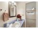 Charming half bath with a vintage mirror and unique vanity next to bedroom at 10324 N 97Th Dr # B, Peoria, AZ 85345