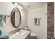 Well-lit bathroom featuring a marble countertop, oval mirror, and neutral color palette at 10324 N 97Th Dr # B, Peoria, AZ 85345