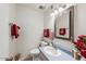 Charming half bath with a vintage mirror and unique vanity at 10324 N 97Th Dr # B, Peoria, AZ 85345