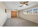 Inviting bedroom featuring dual ceiling fans, and natural light from the large window at 10324 N 97Th Dr # B, Peoria, AZ 85345