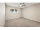 Serene bedroom featuring a modern ceiling fan and bright natural light at 10324 N 97Th Dr # B, Peoria, AZ 85345