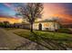 Cozy single-story home with neat front yard and sidewalk, highlighted by a dramatic sky at sunset at 10324 N 97Th Dr # B, Peoria, AZ 85345