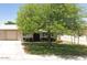 Charming single-story home with a well-maintained lawn, mature tree, and neutral-colored exterior at 10324 N 97Th Dr # B, Peoria, AZ 85345