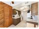 Functional kitchen with wood cabinetry, white appliances, and tiled flooring for easy maintenance at 10324 N 97Th Dr # B, Peoria, AZ 85345