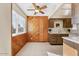 Spacious kitchen with tiled floors, wood cabinets, and a ceiling fan for added comfort at 10324 N 97Th Dr # B, Peoria, AZ 85345