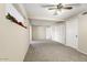 Spacious living room with neutral paint, fan, and ample closet space at 10324 N 97Th Dr # B, Peoria, AZ 85345