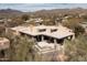 Aerial view featuring the desert home, outdoor patio, and the mountain range in the background at 10687 E Fernwood Ln, Scottsdale, AZ 85262