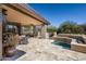 Outdoor patio with a jacuzzi and a desert-style landscape at 10687 E Fernwood Ln, Scottsdale, AZ 85262