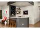 Charming home bar with granite countertop, custom cabinetry, and floating shelves, perfect for entertaining guests at 10687 E Fernwood Ln, Scottsdale, AZ 85262