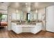 Stylish bathroom featuring double sinks, custom cabinetry, modern lighting, and a large mirror at 10687 E Fernwood Ln, Scottsdale, AZ 85262