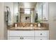 Bathroom featuring a vanity with granite countertop, white cabinetry, and a shower with tiled surround at 10687 E Fernwood Ln, Scottsdale, AZ 85262