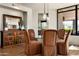 Dining room with a glass table and a buffet with a mirror at 10687 E Fernwood Ln, Scottsdale, AZ 85262