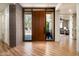 Welcoming entryway featuring a wood door and tile flooring, offering a glimpse into the home's open layout at 10687 E Fernwood Ln, Scottsdale, AZ 85262