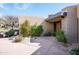 Desert home exterior featuring a covered patio and desert landscaping at 10687 E Fernwood Ln, Scottsdale, AZ 85262