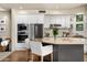 Well-appointed kitchen featuring stainless appliances, an island with bar seating, and modern white cabinetry at 10687 E Fernwood Ln, Scottsdale, AZ 85262