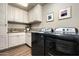 Laundry room with side by side washer and dryer and storage cabinets at 10687 E Fernwood Ln, Scottsdale, AZ 85262